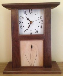 This variation on the Arts and Crafts panel clock has a sycamore panel, rosewood inlay and a jet bud.