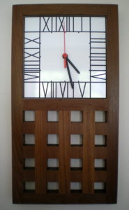 This Rennie Mackintosh style wall clock has a laminate face and a latice work base