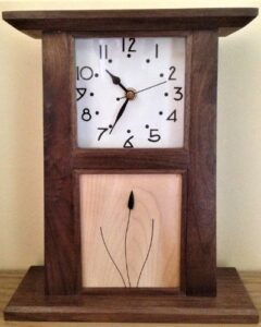 This mantle clock is made in American Black Walnut and features a piece of jet in the base panel.