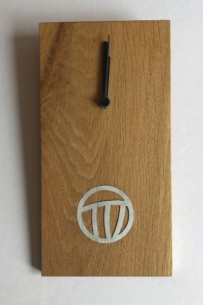 This small teak wall clock has a pewter inlay inspired by the Mackintosh rose design.