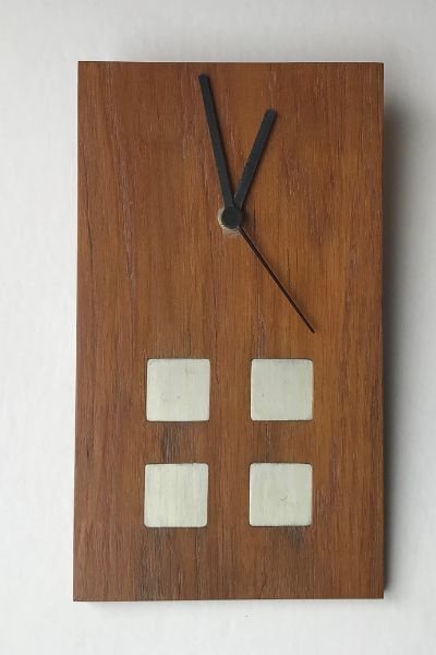 This is a Charles Rennie Mackintosh style clock with four pewter squares