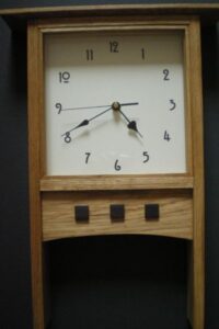 This is a mantle clock based on a Charles Rennie Mackintosh design and features three wooden rosewood squares.