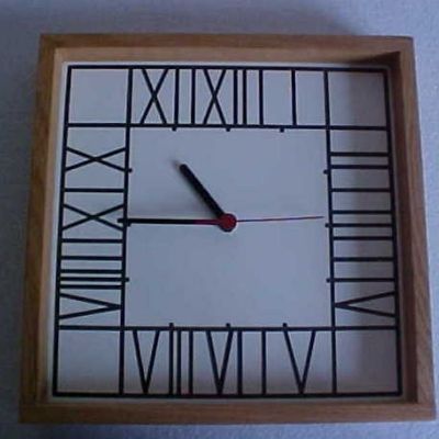 This square dovetailed wall clock has a Mackintosh inspired face.