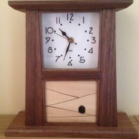 This version of the Arts and Crafts panel clock has a sycamore panel inlaid with rosewood and jet