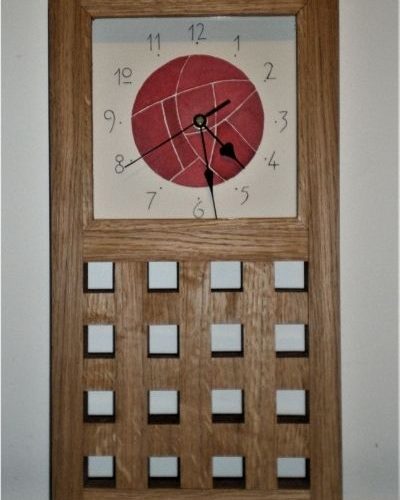 This large wall clock was commissioned for a ruby wedding and the face is based on the Mackintosh rose design.